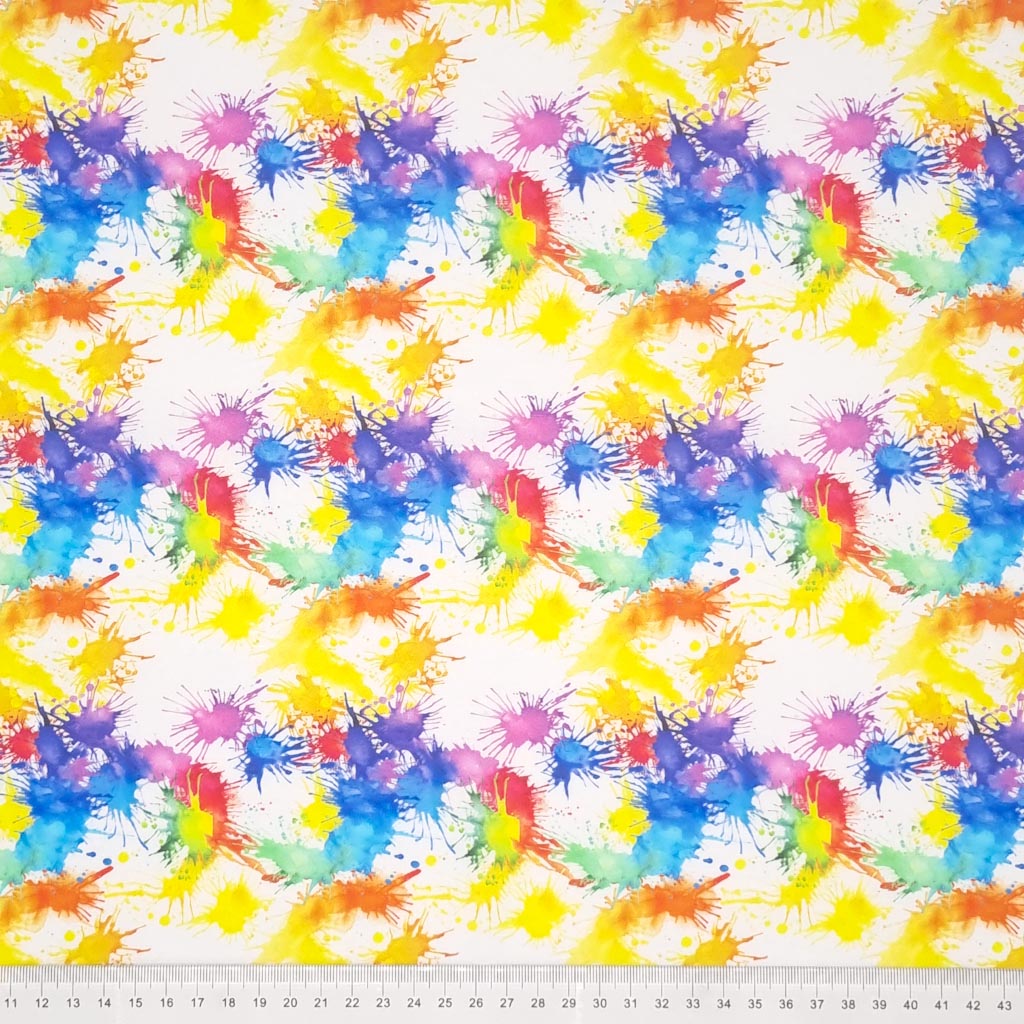 Blue, red, green, purple and yellow paint splashes are digitally printed on a quality white 100% cotton fabric with a cm ruler at the bottom