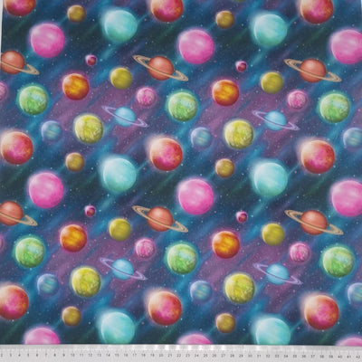 Colourful planets printed on a cotton fabric with a cm ruler