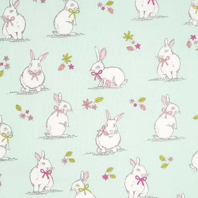 An endearing woodlland scene featuring bunny rabbits, all printed on a duck egg, 100% cotton fabric.