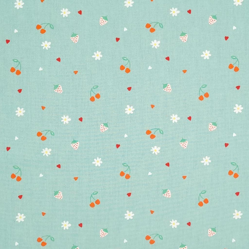 Cherries, strawberries, flowers and hearts are printed on a mint coloured cotton poplin.
