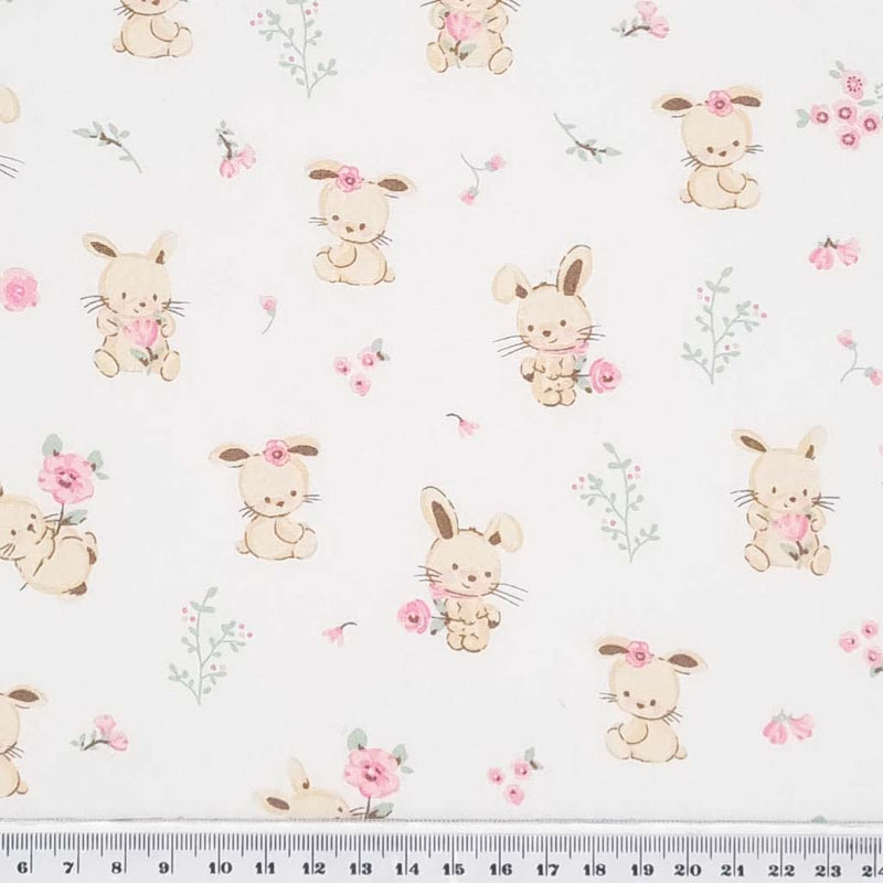 Cute bunnies and pink flowers printed on a white cotton poplin fabric with a cm ruler