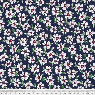Pretty white daisy flowers printed on a navy, lightweight cotton poplin fabric with a cm ruler