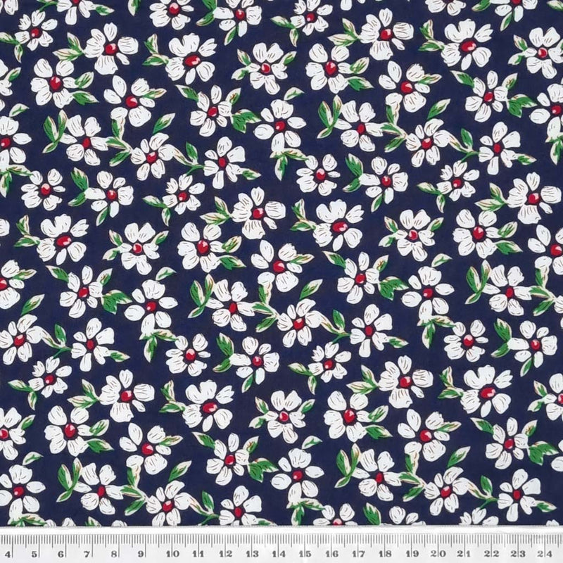 Pretty white daisy flowers printed on a navy, lightweight cotton poplin fabric with a cm ruler