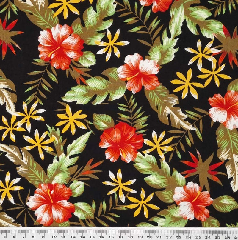 A tropical sunshine floral design printed on a black, lightweight cotton poplin fabric with a cm ruler