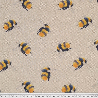 Large bumblebees are printed on a craft canvas fabric with a cm ruler