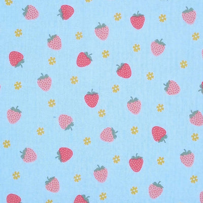 Red and pink strawberries with little yellow flowers are printed on a light blue double gauze fabric.