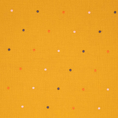 Embroidered dots printed on an ochre double gauze fabric.