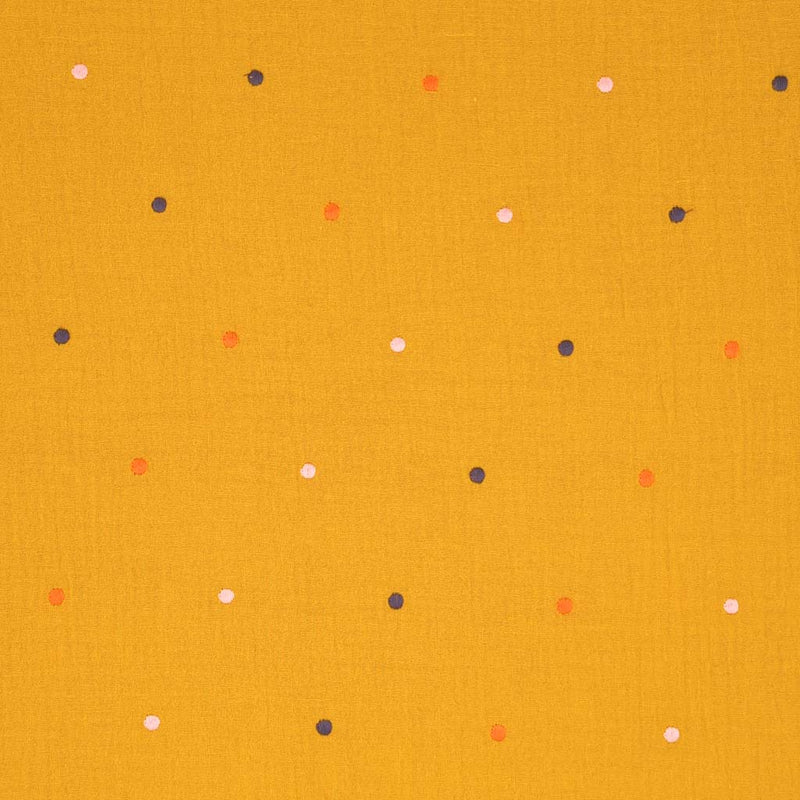 Embroidered dots printed on an ochre double gauze fabric.