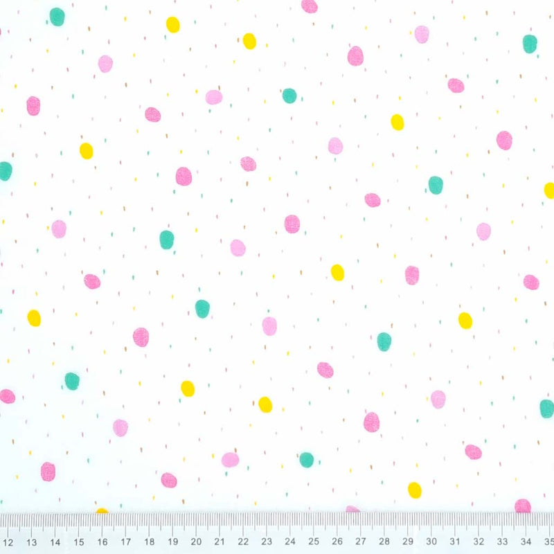 Colourful rainy dots printed on a white double gauze fabric with a cm ruler at the bottom