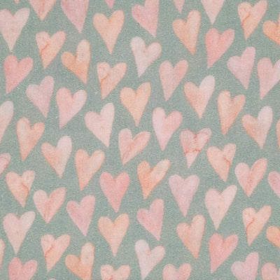 Large rose coloured hearts printed on an organic, mint double gauze fabric