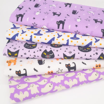 A fat quarter bundle of 6 halloween fabrics with black cats and witches hats in lilac colours