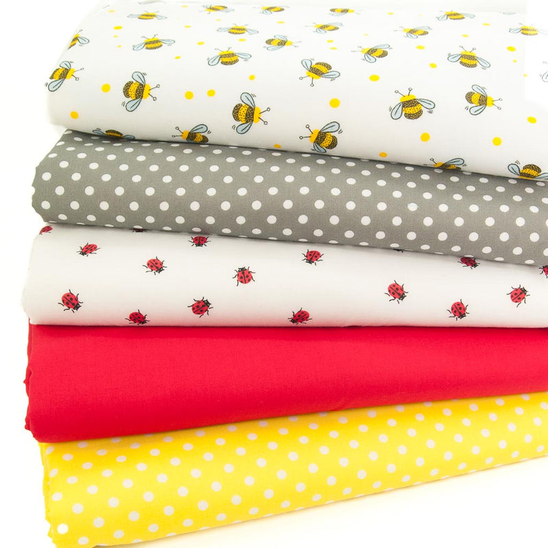 Five polycotton fabric prints stacked in a fat quarter bundle with yellow and black bees, grey spots and red ladybirds