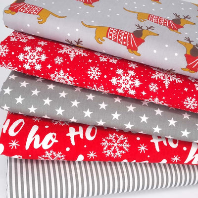 A fat quarter bundle in grey and red with festive dachshund dogs, stars and stripes