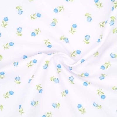 Blue baby roses are printed on a white polycotton fabric