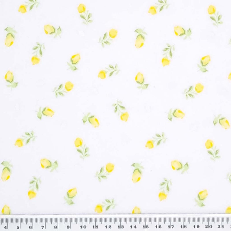 A small and delicate lemon yellow baby rose printed on a quality white polycotton fabric with a cm ruler