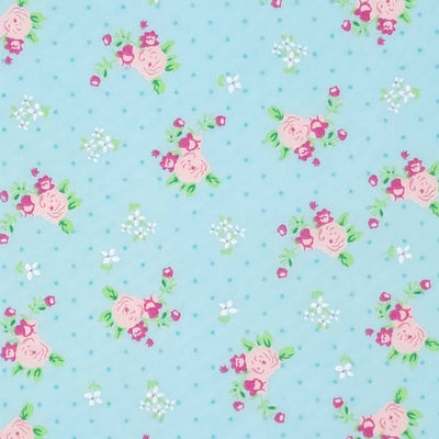 A beautiful pink, vintage blooming rose polycotton fabric print on a turquoise blue background