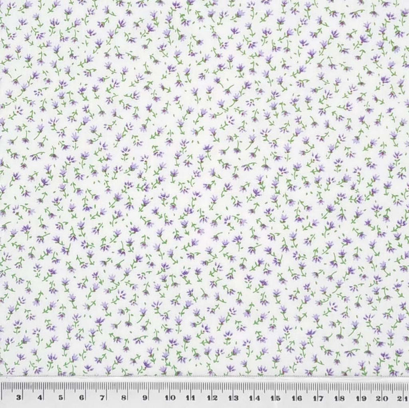 A delicate ditsy lilac floral print on a quality white polycotton fabric with a cm ruler