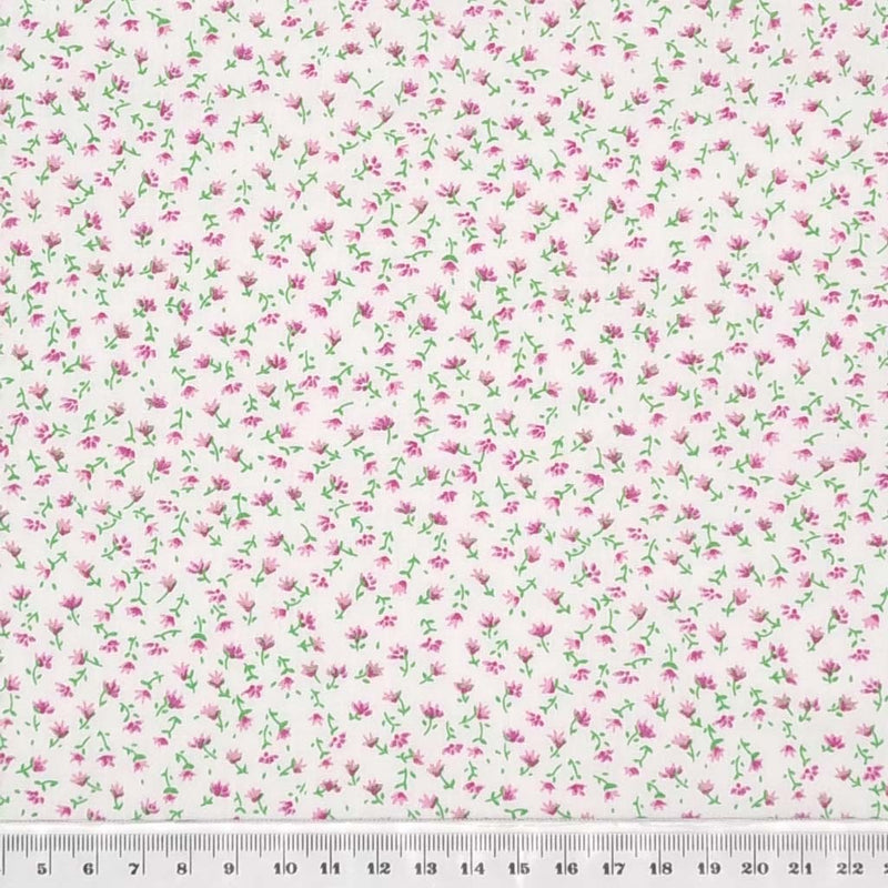 A delicate ditsy pink floral print on a quality white polycotton fabric with a cm ruler