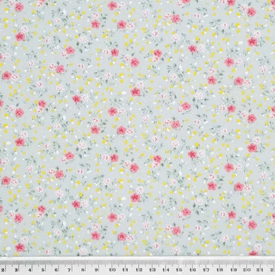 A delicate ditsy floral polycotton in mint with a cm ruler