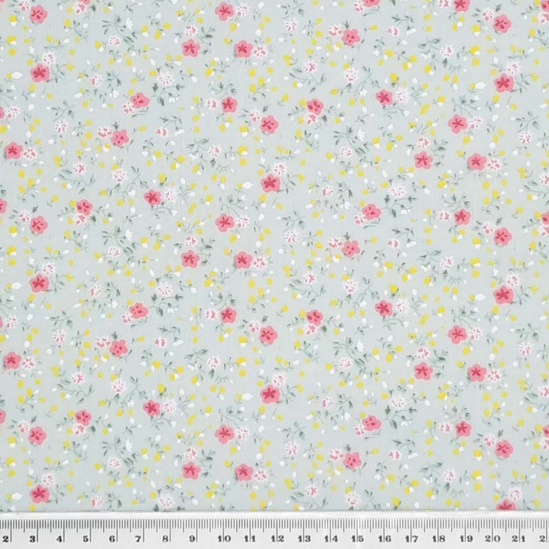 A delicate ditsy floral polycotton in mint with a cm ruler