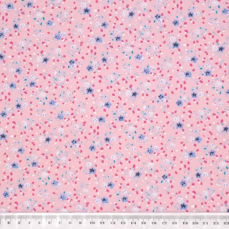 A delicate ditsy floral polycotton in pink with a cm ruler