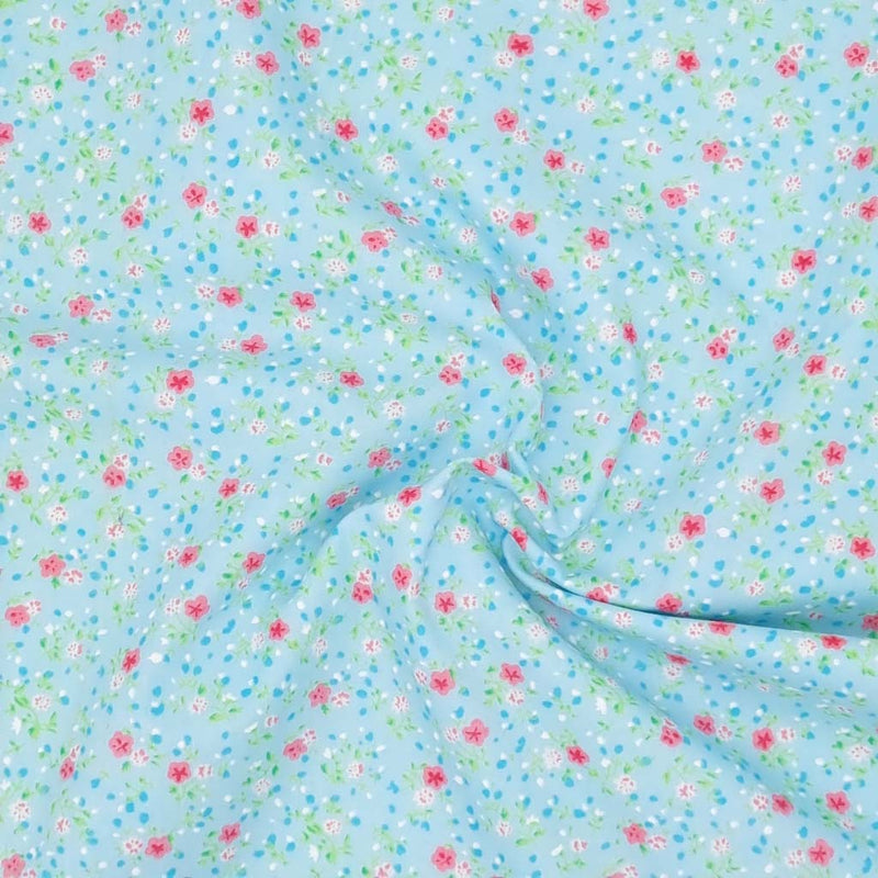 A delicate ditsy floral polycotton in turquoise.