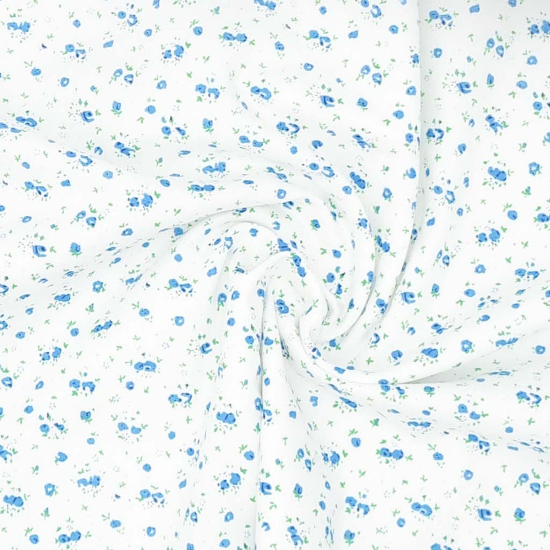 A ditsy blue rose bud fabric print on polycotton
