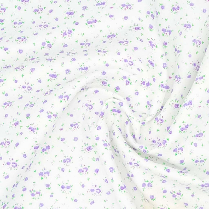 A ditsy lilac rose bud fabric print on polycotton