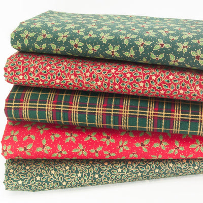 Red and green cotton christmas fabrics in a fat quarter bundle with holly and tartan and gold lacquer detail