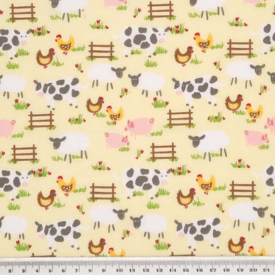Chickens, sheep, pigs and cows are printed on a lemon yellow polycotton fabric with a cm ruler
