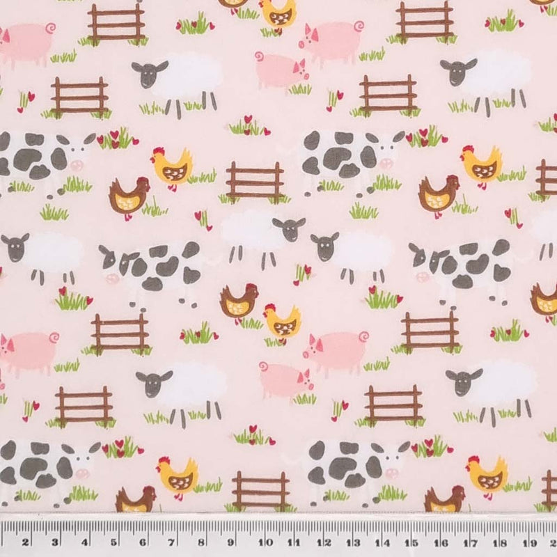 Chickens, sheep, pigs and cows are printed on a pale pink polycotton fabric with a cm ruler