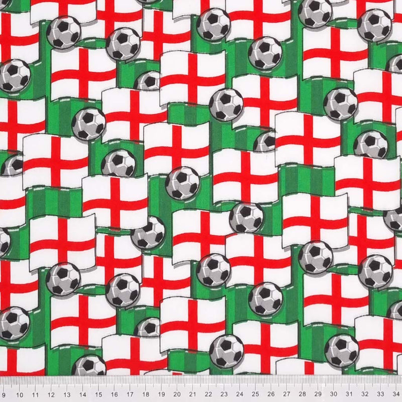 Footballs and England flags are scattered over a football pitch printed on polycotton fabric with a cm ruler at the bottom