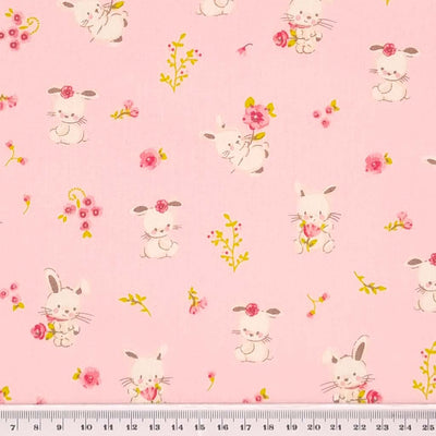 Sweet bunny rabbits printed on a pink, organic cotton poplin fabric with a cm ruler