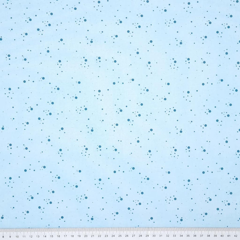 Teal speckled spots printed on a sky blue, 100% cotton fabric with a cm ruler at the bottom