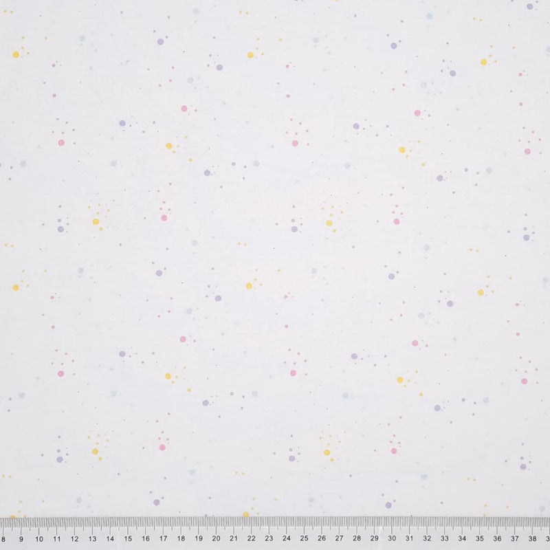 Pastel speckled spots printed on a white, 100% cotton fabric with a cm ruler at the bottom