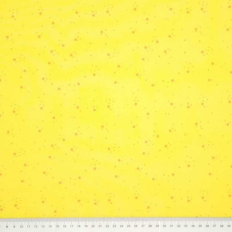 Orange speckled spots printed on a yellow, 100% cotton fabric with a cm ruler at the bottom