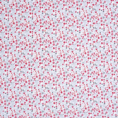 A light grey jersey fabric printed with ditsy red flowers with pointoille lace detail
