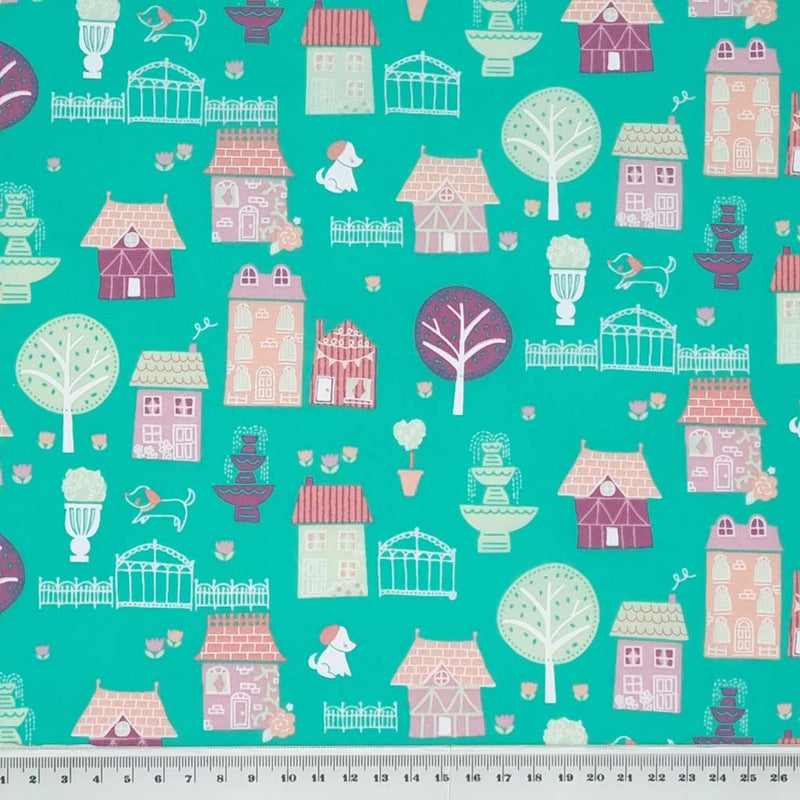 A quaint town scene around the houses with dogs, trees and fountains, all printed on a quality, green polycotton fabric with a cm ruler