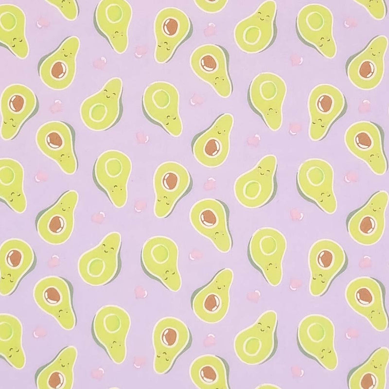 Smiling avocados are printed on a quality lilac polycotton fabric