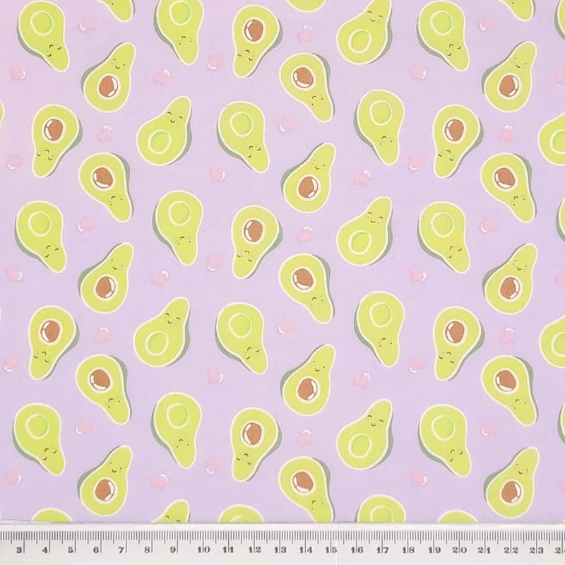 Smiling avocados are printed on a quality lilac polycotton fabric with a cm ruler