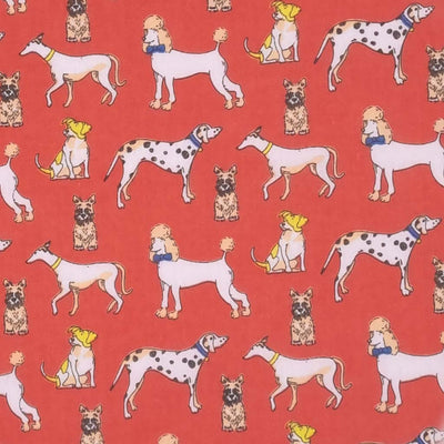 Poodles, dalmatians and terriers appear on this pet lovers polycotton fabric print on red
