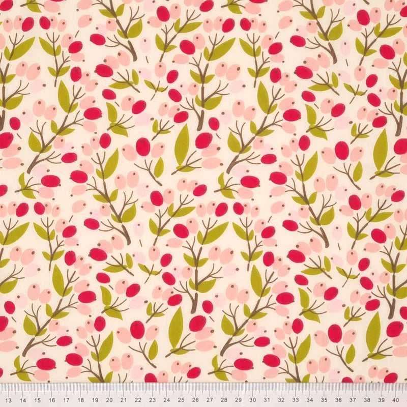 A floral design with cerise and pink berries printed on a cream polycotton fabric with a cm ruler at the bottom