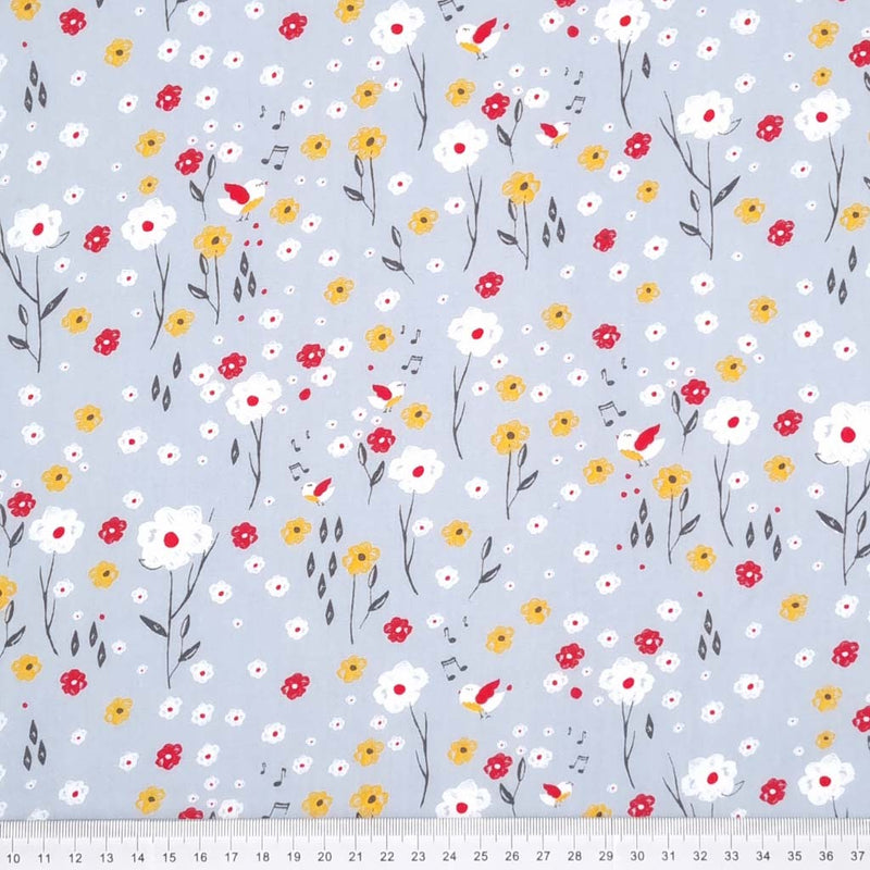 Flowers and happy singing birds are printed on a grey polycotton fabric with a cm ruler at the bottom