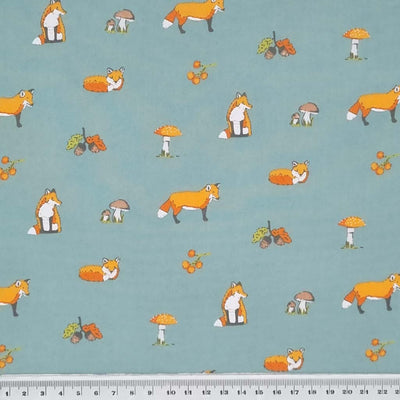 Foxes and toadstools with acorns and berries are printed on a quality, sage green polycotton fabric with a cm ruler