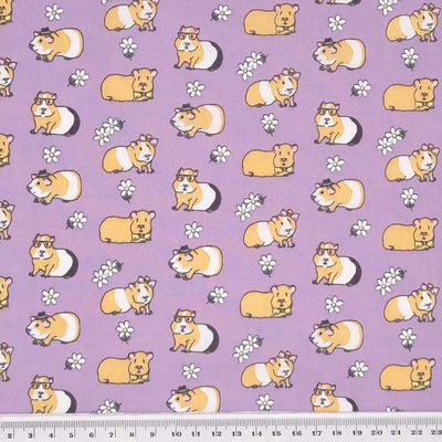 Guinea pigs sporting bow ties, glasses, hair bows and hats are printed on a quality lilac polycotton fabric with a cm ruler
