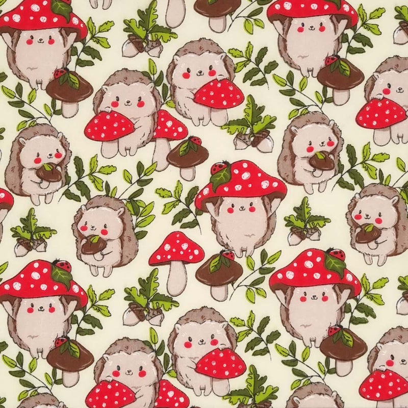 Cute hedgehogs and toadstools with ladybirds are printed on a cream polycotton fabric