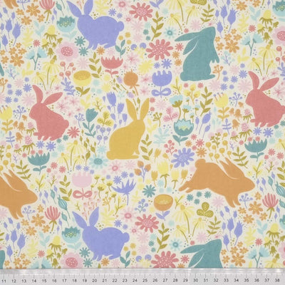 Easter bunnies printed on a cream polycotton fabric with a cm ruler at the bottom