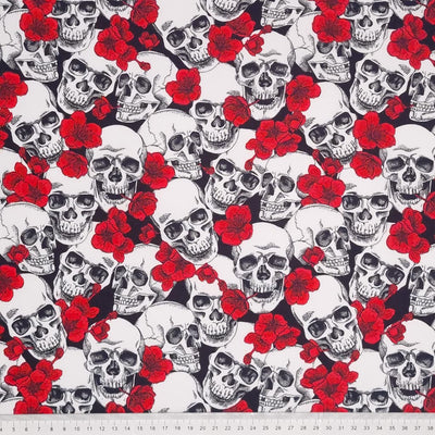 Gothic skulls and red poppies on a black,100% cotton poplin fabric with a cm ruler at the bottom