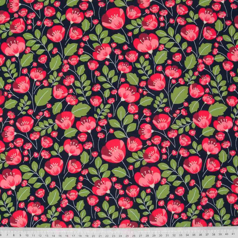 Small red poppies and green leaves are printed on a navy 100% cotton poplin fabric with a cm ruler at the bottom