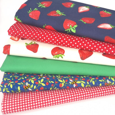 A bundle of 6 Rose & Hubble fabric fat quarters with strawberries, spots, gingham and bees.